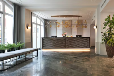 Logo image of Classik Hotel Collection placed over a modern hotel lobby background.